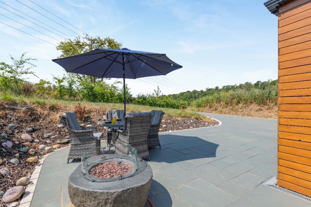 Stone patio with fire pit and outdoor seating at Maroc