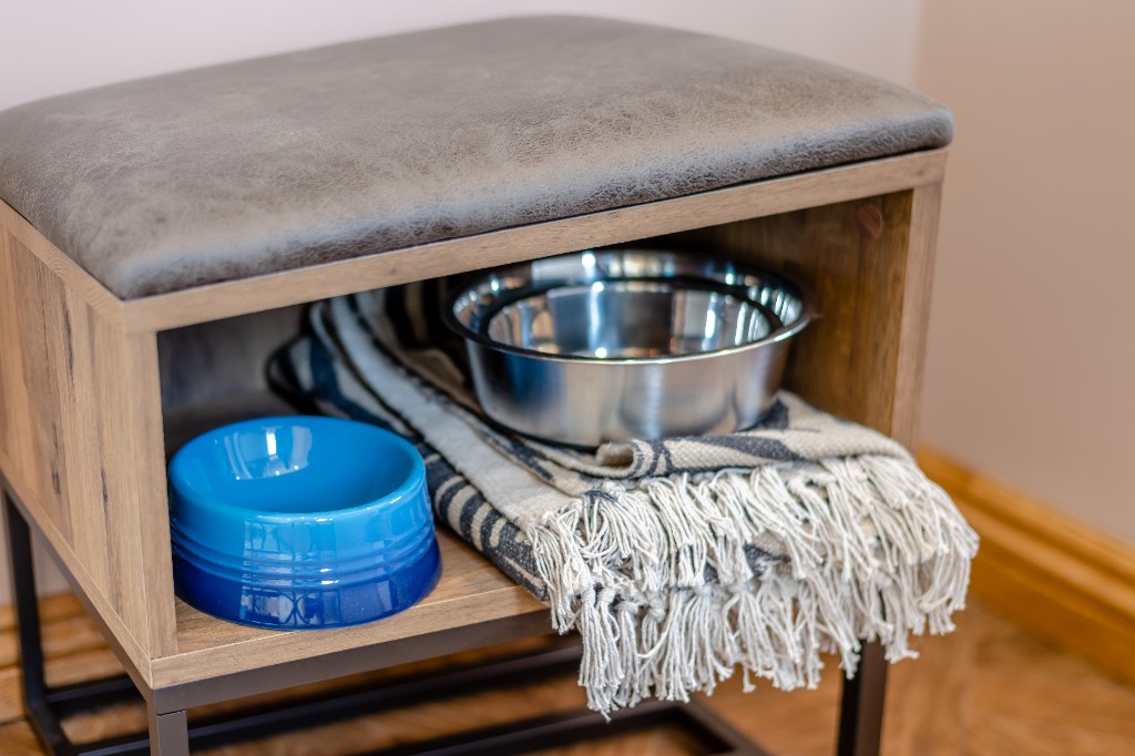 Dog-friendly pet station with bowls and blanket