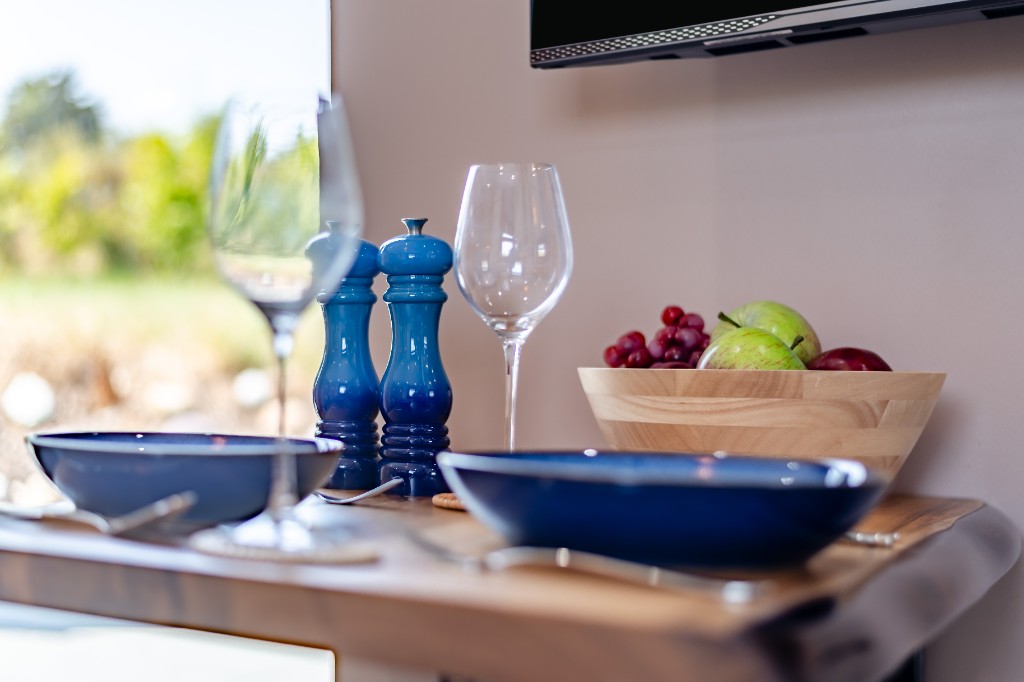 Wall-mounted dining table set for two with garden views