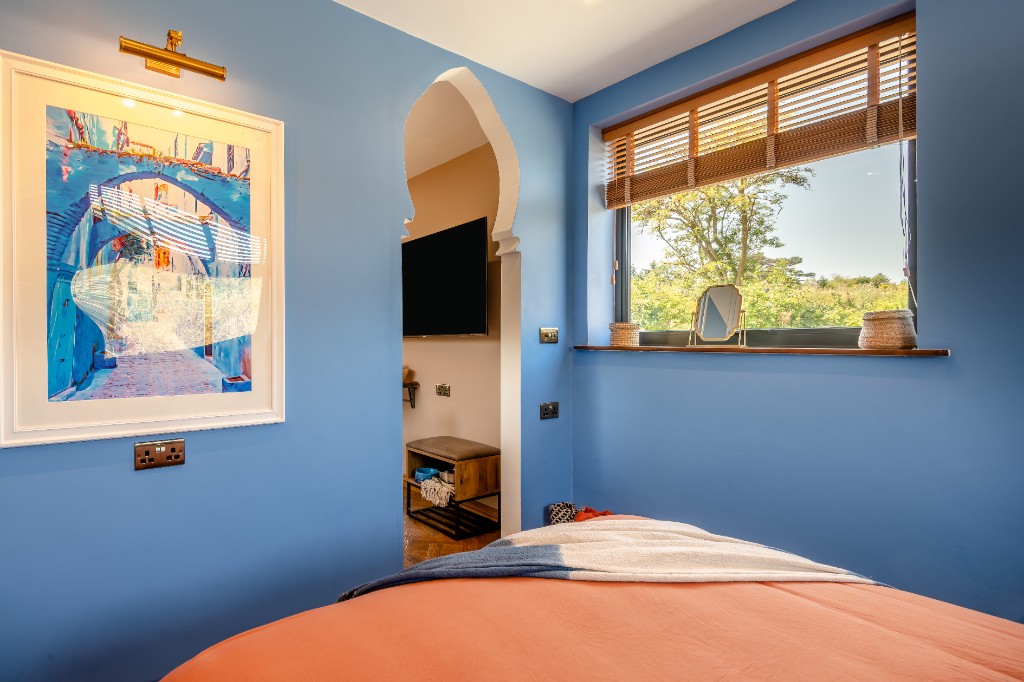 Bedroom view through Moroccan arched doorway